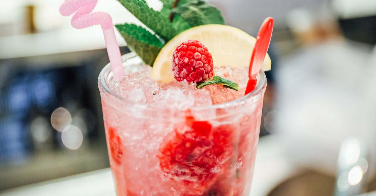 A cocktail glass beside a calorie tracking log on a phone